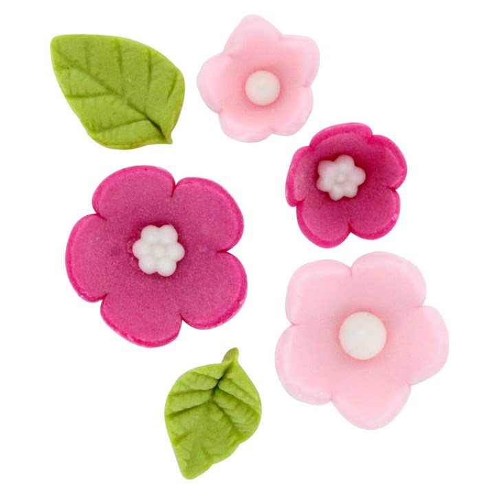 Set of pink and green floral sugar decorations on a white background