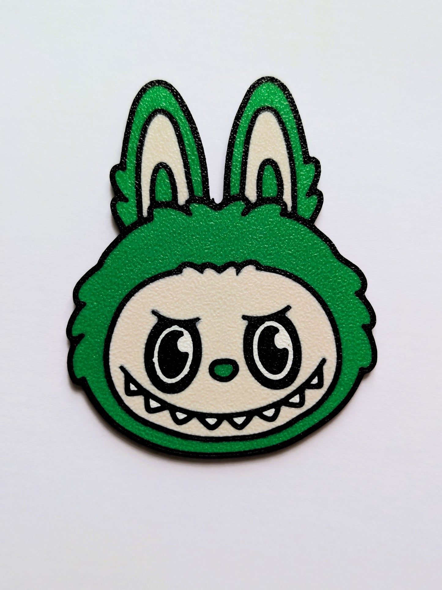Green Labubu/Lafufu character with a grumpy expression on a white background