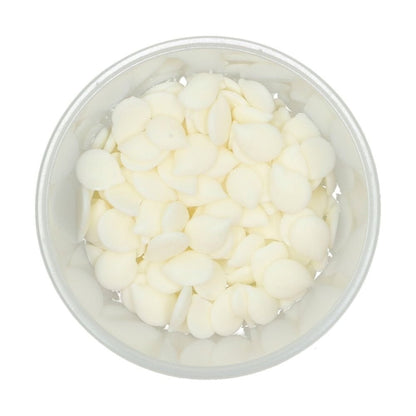 Clear container filled with bright white Wilton candy melts on a white background