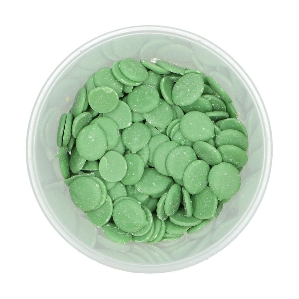 Clear container filled with green wilton chocolate melts on a white background