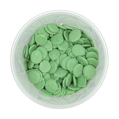 Clear container filled with green wilton chocolate melts on a white background