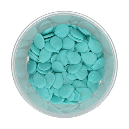 light blue wilton candy melts in a clear container on a white background