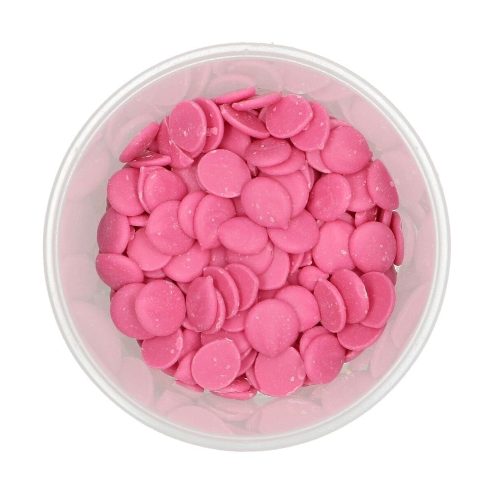 Clear container filled with pink round candies on a white background