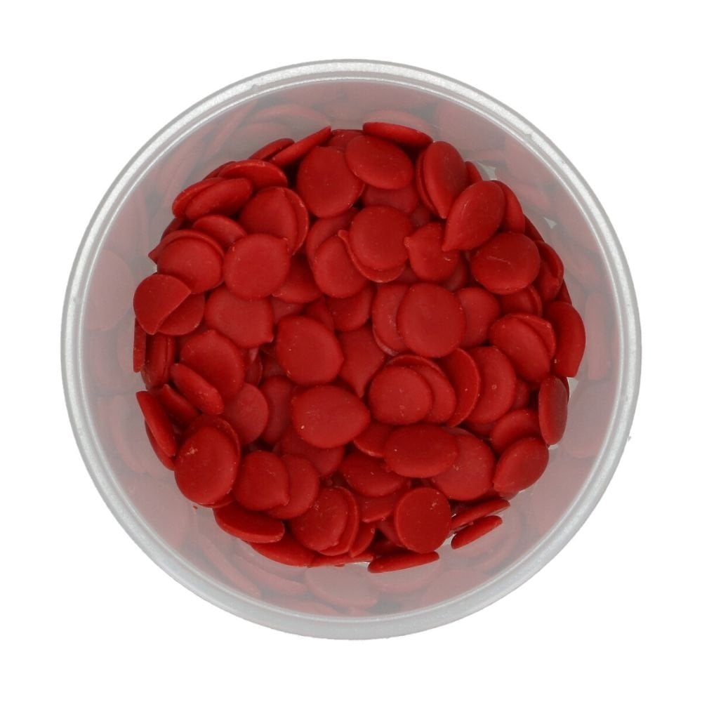 Clear plastic container filled with red round Wilton candy melts on a white background