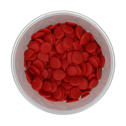 Clear plastic container filled with red round Wilton candy melts on a white background
